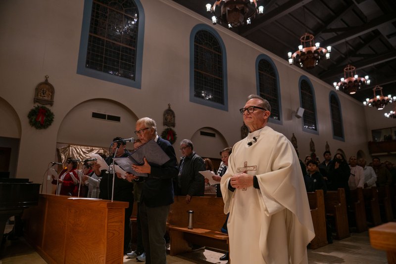 Father Gilbert Guzman, pastor of Sacred Heart Church in Altadena, processes in during a Jan. 7 healing Mass on the one-year anniversary of the Eaton Fire. (John Rueda)