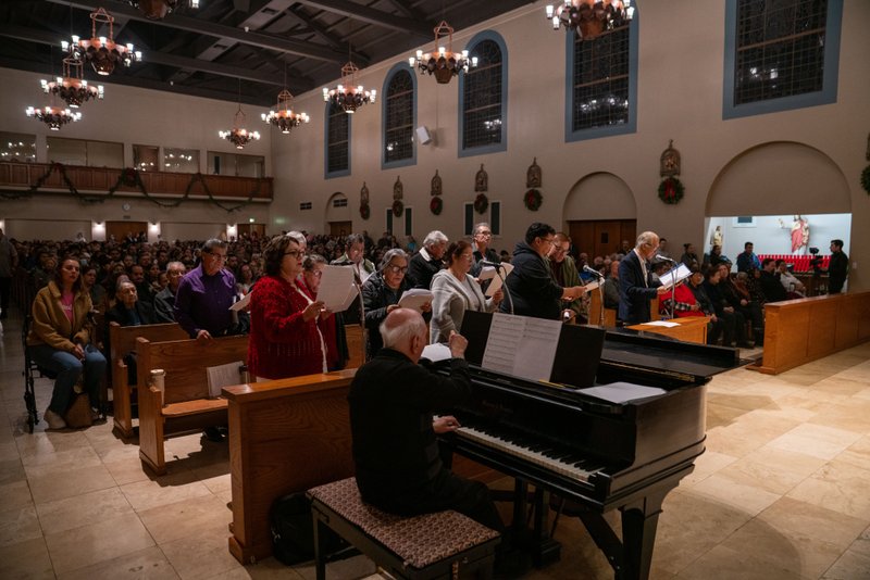 The choir performs at Sacred Heart Church in Altadena during a Jan. 7 healing Mass on the one-year anniversary of the Eaton Fire. (John Rueda)