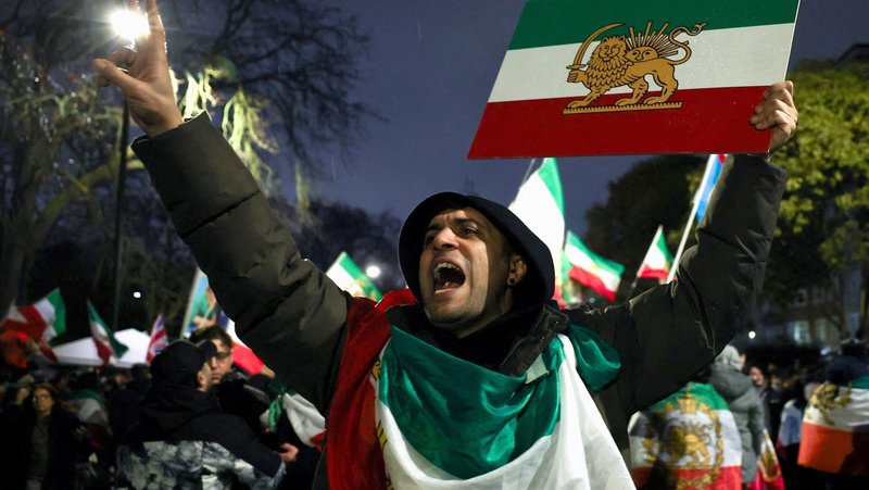 A man gestures while displaying the "Lion and Sun" pre-Iranian Revolution national flag as demonstrators gather outside the Iranian Embassy in London Jan. 11, 2026, during a rally in support of nationwide protests in Iran. (OSV News photo/Isabel Infantes, Reuters)