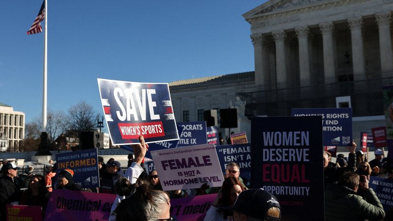 Supporters of female sports participation based on biological sex hold placards outside the U.S. Supreme Court in Washington Jan. 13, 2026, on the day justices are expected to hear oral arguments in two cases concerning efforts to enforce state laws banning transgender athletes from female sports teams at public schools. (OSV News photo/Tyrone Siu, Reuters)