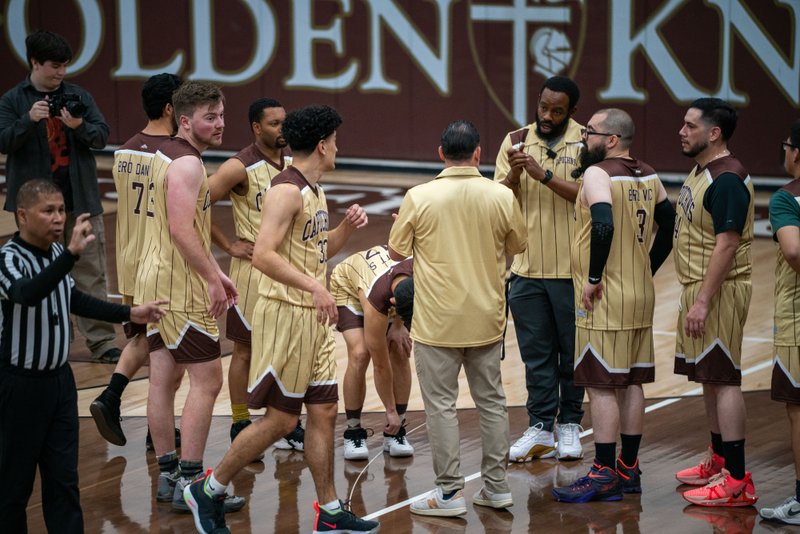 The Capuchin Franciscans huddle up during a timeout while playing against the seminarians in the Archdiocese of Los Angeles' annual priests vs. seminarians basketball game, this year on Jan. 18 at St. Francis High School in La Cañada Flintridge. (John Rueda)
