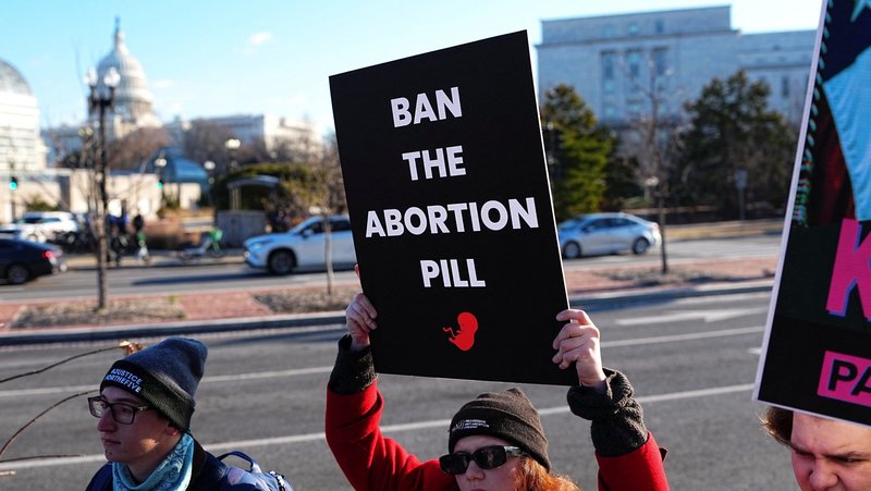 Demonstrators hold banners during a protest outside the U.S. Department of Health and Human Services in Washington Jan. 22, 2026, to call on President Donald Trump's administration to ban the abortion pill. (OSV News/Aaron Schwartz, Reuters)