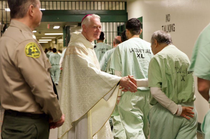 Auxiliary Bishop Matt Elshoff greets inmates as he celebrated Christmas Day Mass at Men’s Central Jail near downtown LA. (Reese Cuevas)