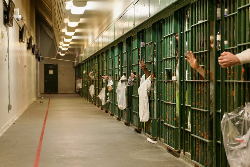 Bishop Matthew Elshoff handed out copies of the St. Carlo Acutis-inspired book “3 Days to Eucharistic Fire” to inmates after celebrating Christmas Day Mass at Men’s Central Jail near downtown LA. (Reese Cuevas)