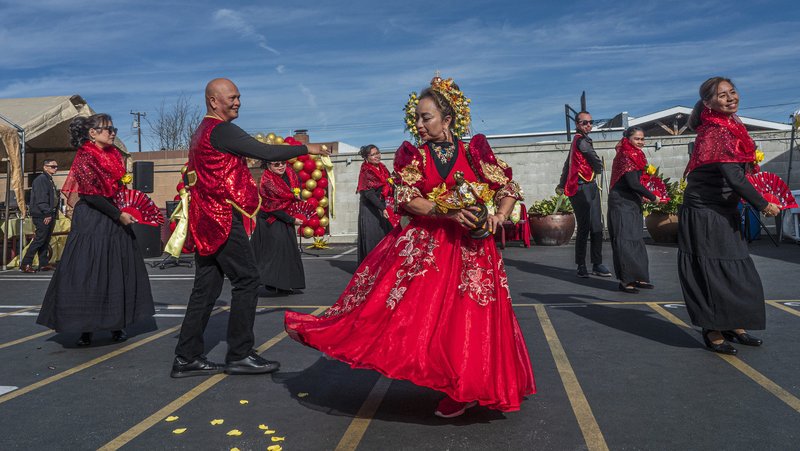 J.K. Cortez, left, and Delia Harvey, center, are part of a traditional Sinulog dance during the celebration after a Santo Niño Mass held at St. Philomena Church in Carson on Jan. 17. (Juanito Holandez Jr.)