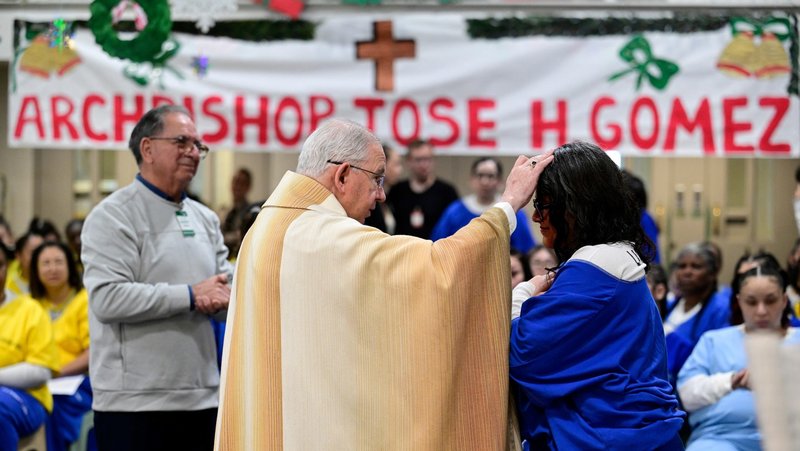 Archbishop José H. Gomez blesses an inmate at Century Regional Detention Facility in Lynwood, LA County’s largest women’s jail, during Christmas Mass Dec. 25, 2025. (John McCoy)