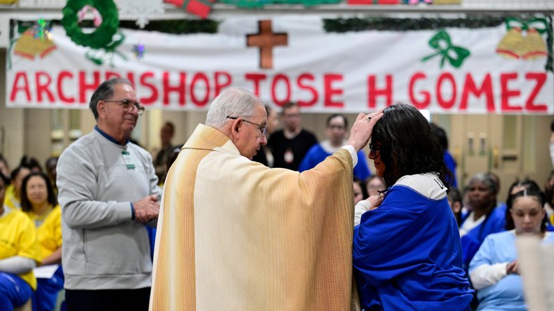 Archbishop José H. Gomez blesses an inmate at Century Regional Detention Facility in Lynwood, LA County’s largest women’s jail, during Christmas Mass Dec. 25, 2025. (John McCoy)
