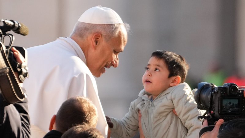 Pope Leo XIV greets a child from the popemobile as he rides around St. Peter's Square at the Vatican before his weekly general audience Dec. 31, 2025. (CNS photo/Lola Gomez)