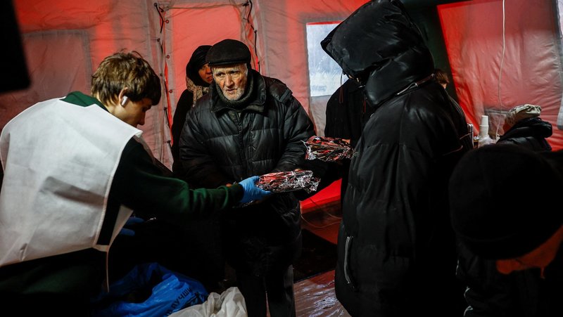 Residents receive hot meals inside a tent at a government-run humanitarian aid point in Kyiv, Ukraine, Jan. 23, 2026, as other locals warm up, charge their devices there, during a power blackout after critical civil infrastructure was hit by overnight Russian missile and drone strikes, amid Russia's full-scale invasion of Ukraine. (OSV News/Alina Smutko, Reuters)