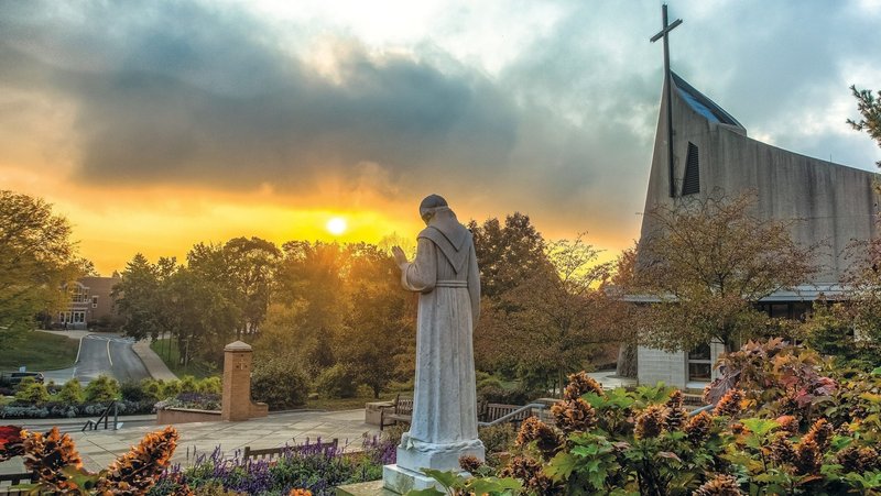 A file photo shows a statue and church on the campus of the Franciscan University of Steubenville, Ohio. (OSV News photo/courtesy Franciscan University of Steubenville)