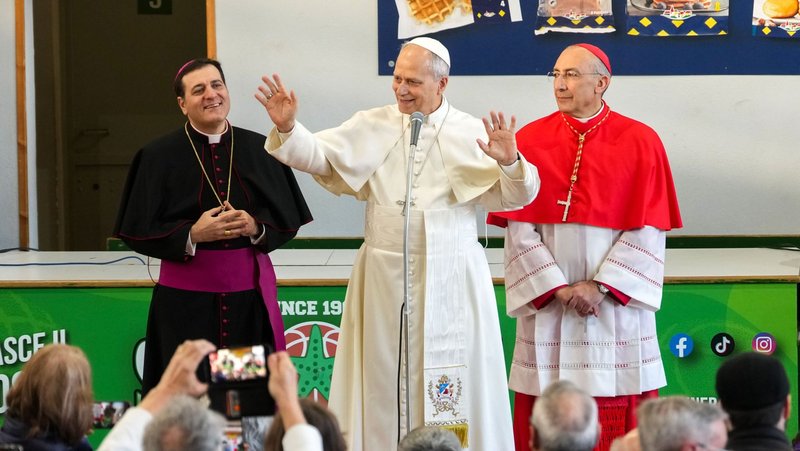 Pope Leo XIV greets parishioners as he meets members of the Parish of Santa Maria Regina Pacis during a pastoral visit in Ostia Lido, Italy, Feb. 15, 2026, accompanied by Bishop Renato Tarantelli Beccari, vice-regent of the Diocese of Rome, left, and Cardinal Baldassare Reina, papal vicar of Rome, right. (CNS photo/Lola Gomez)