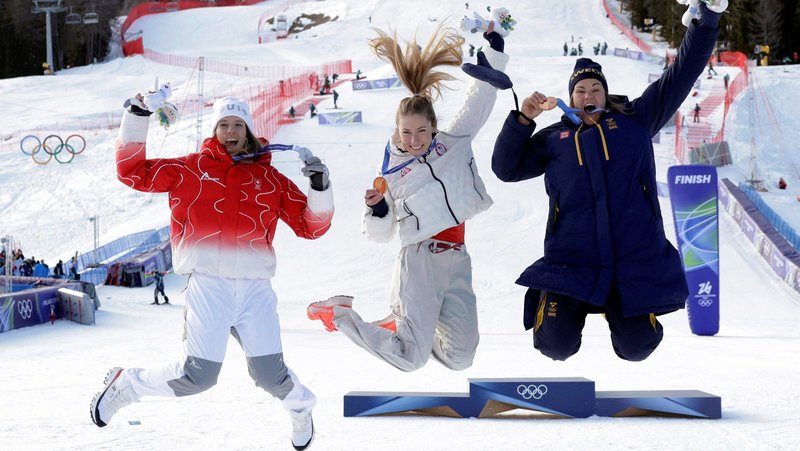 Gold medallist Mikaela Shiffrin of United States, center, celebrates on the podium after winning Alpine Skiing - Women's Slalom with silver medallist Camille Rast of Switzerland and bronze medallist Anna Swenn Larsson of Sweden during the Milano Cortina 2026 Olympics during the Women's Slalom Victory Ceremony at Tofane Alpine Skiing Center in Belluno, Italy, Feb. 18, 2026. (OSV News photo/Leonhard Foeger, Reuters)