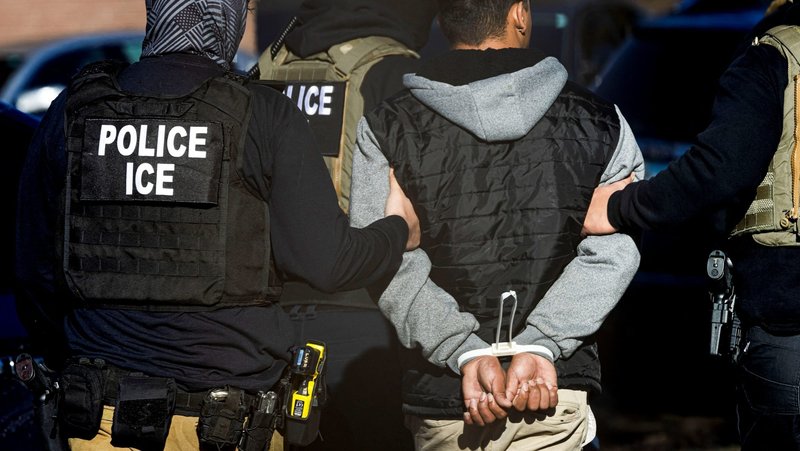 Agents with the Immigration and Customs Enforcement detain a man after conducting a raid at the Cedar Run apartment complex in Denver Feb. 5, 2025. (OSV News photo/Kevin Mohatt, Reuters)