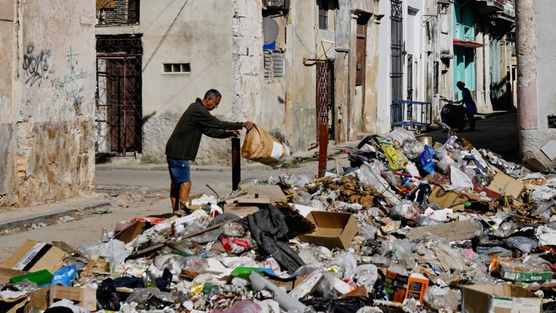 A man throws trash on a street in downtown Havana Feb. 15, 2026. Amid fuel shortages, garbage is not picked up in Cuba's capital. Representatives and clergy of the Archdiocese of Miami accompanied a series of ongoing humanitarian relief shipments to Cuba Jan. 28, following last year’s hurricane. (OSV News photo/Norlys Perez, Reuters)