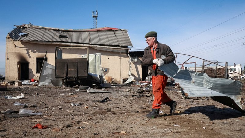 A resident cleans an area at the site of a Russian drone strike near Chornomorsk, Ukraine, Feb. 23, 2026. (OSV News photo/Nina Liashonok, Reuters)