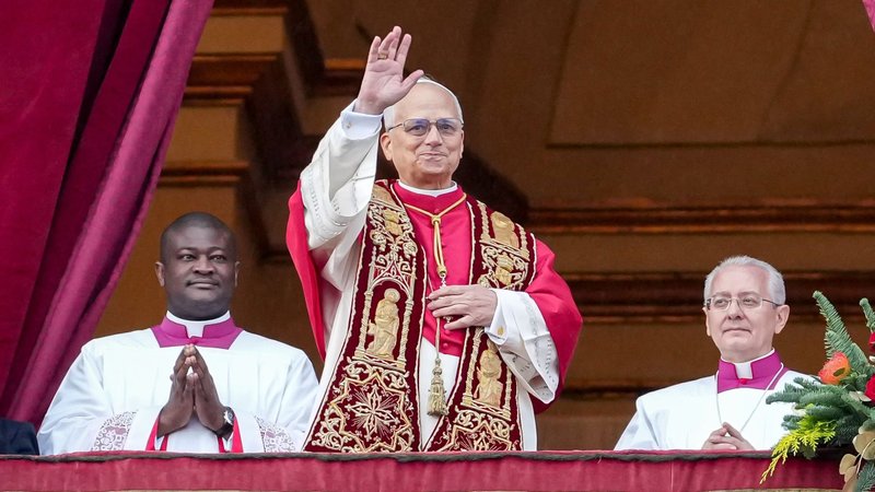 Pope Leo XIV waves to visitors gathered in St. Peter's Square after delivering his Christmas message and blessing "urbi et orbi" (to the city and the world) from the central balcony of St. Peter's Basilica at the Vatican Dec. 25, 2025. (CNS photo/Lola Gomez)