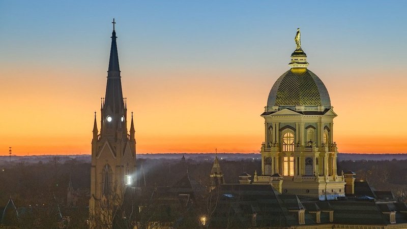 The sun sets over the main building and Basilica of the Sacred Heart steeple on the campus of the University of Notre Dame in South Bend, Ind., Nov. 23, 2025. (OSV News photo/Matt Cashore, courtesy University of Notre Dame)