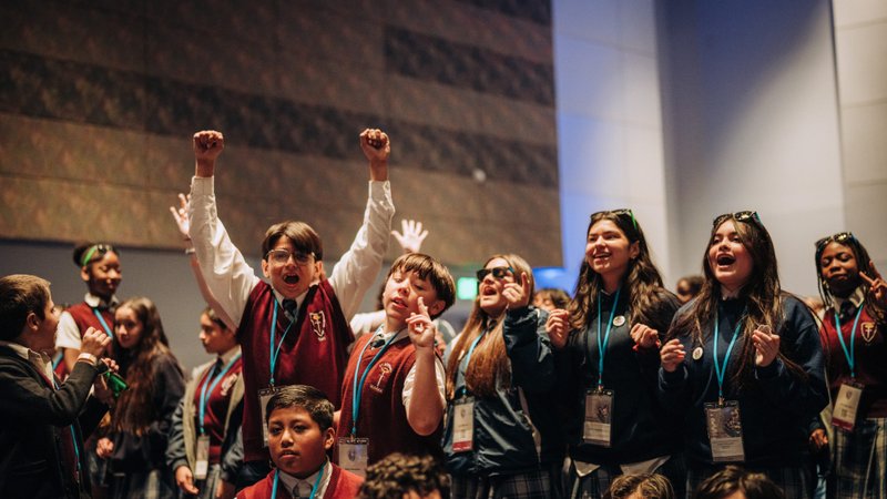 Students stand on chairs and cheer as middle-schoolers were added for the first time to the Archdiocese of Los Angeles’ Religious Education Congress Youth Day on Feb. 19. (Isabel Cacho)