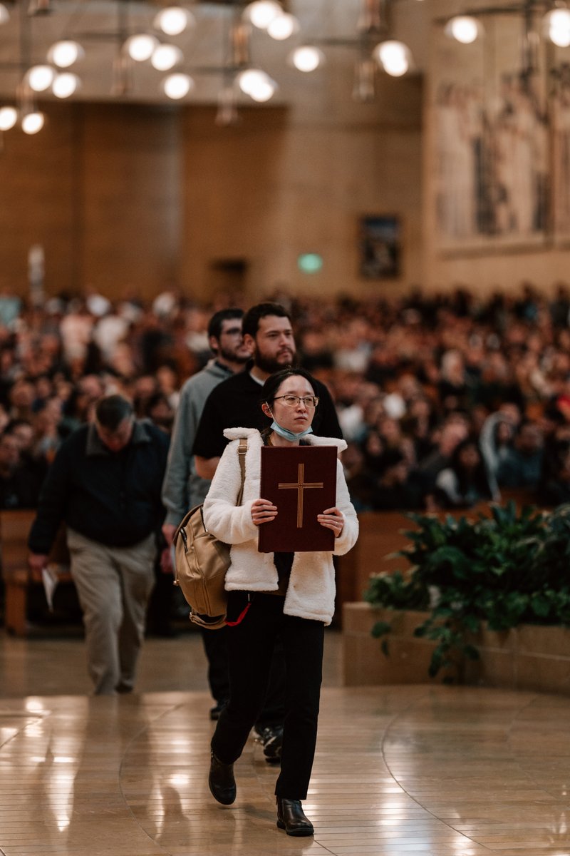 Catechists and catechumens process to the altar with the Book of the Elect during the Rite of Election ceremony at the Cathedral of Our Lady of the Angels on Feb. 15. (Peter Lobato)