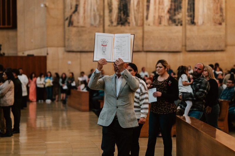 Catechists and catechumens process to the altar with the Book of the Elect during the Rite of Election ceremony at the Cathedral of Our Lady of the Angels on Feb. 15. (Peter Lobato)