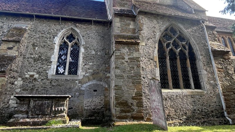 St. James Church in the village of Shere, in Surrey, England. The outline of the cell (with a small window) where the anchoress Christine Carpenter lived is visible below the left church window. (Shemaiah Gonzalez)