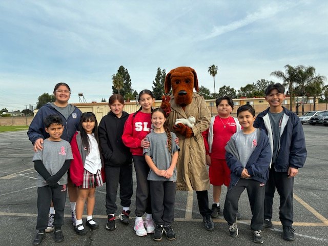 Students at St. Linus School in Norwalk pose with McGruff the Crime Dog during Catholic Schools Week. (St. Linus School)