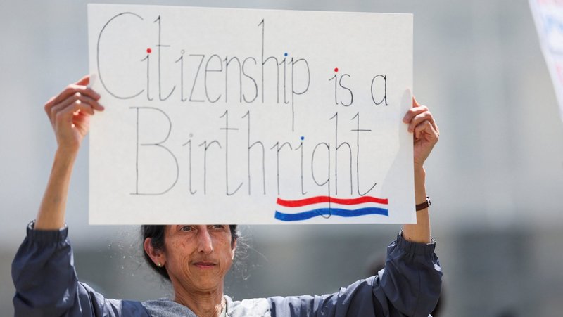 A demonstrator holds a placard during a protest outside the Supreme Court May 15, 2025, as the justices heard oral arguments in Trump v. CASA related to lower courts placing an injunction on Trump's executive order of Jan. 20, 2025, to end birthright citizenship. In a 6-3 ruling, the Supreme Court June 27 limited the scope of federal courts to block presidential policies nationwide. On April 1, 2026, the court will hear oral arguments in Trump v. Barbara, a challenge to the order ending birthright citizenship. (OSV News photo/Leah Millis, Reuters)