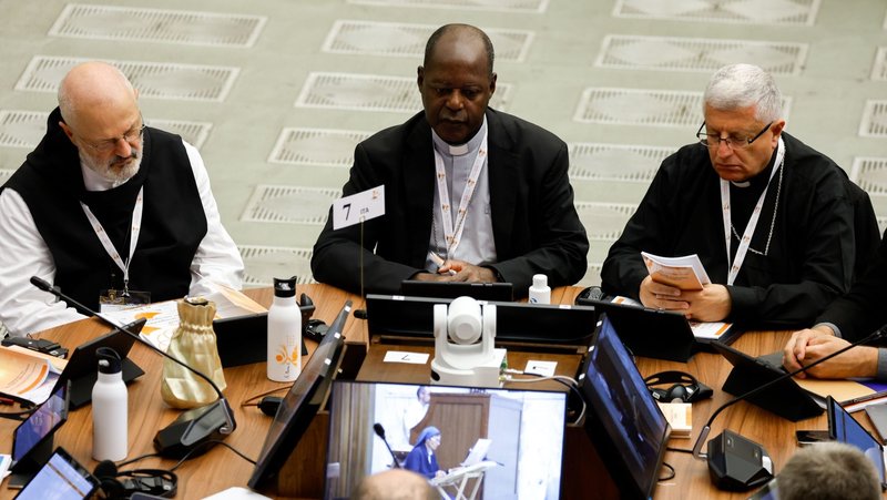 Participants pray in the Vatican's Paul VI Audience Hall at the beginning of a working session of the assembly of the Synod of Bishops Oct. 10, 2023. (CNS/Lola Gomez)