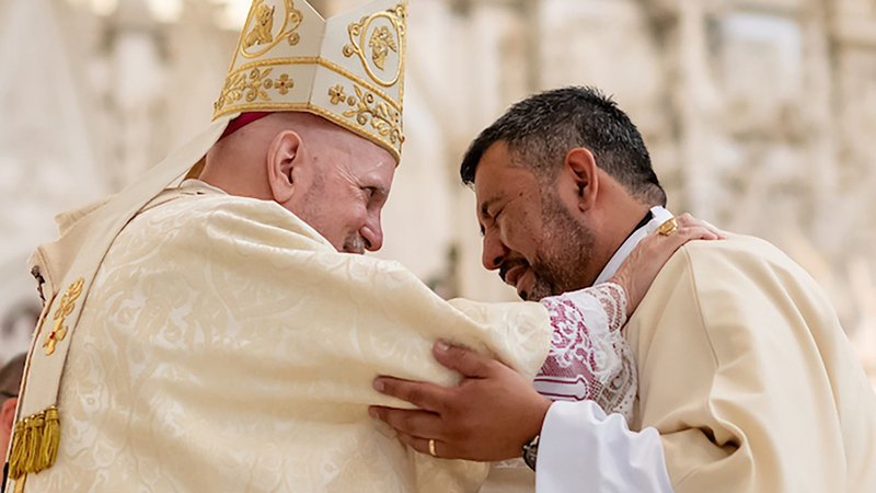 Denver Archbishop Samuel J. Aquila embraces Deacon Abram Leon during a permanent deacon ordination at the Cathedral Basilica of the Immaculate Conception in Denver June 14, 2025. (OSV News/Daniel Petty, Denver Catholic)
