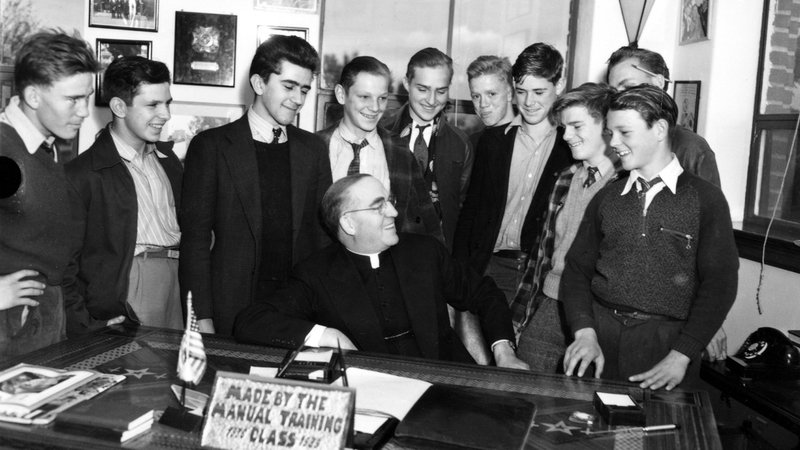 Father Edward Flanagan is surrounded by young men in his office at Boys Town in Omaha, Neb., in this 1942 photo. Pope Leo XIV declared Father Flanagan, the founder of Boys Town, venerable in recognition of his heroic virtue March 23, 2026. (OSV News photo/courtesy Boys Town)