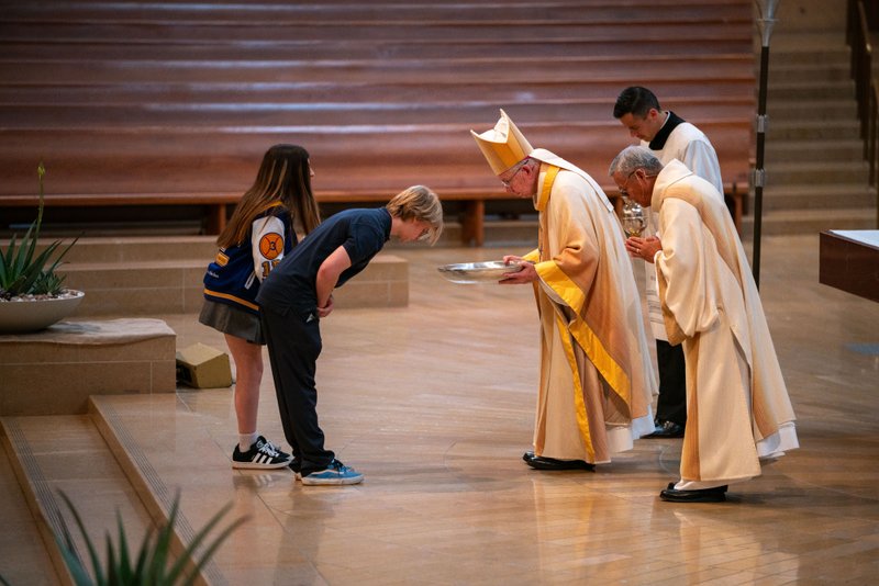 Archbishop José H. Gomez bows to students bringing up the gifts during the 2026 Christian Service Awards Mass on March 10 at the Cathedral of Our Lady of the Angels. (John Rueda)