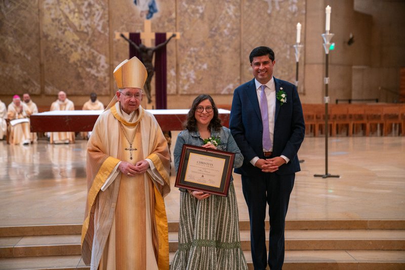 Archbishop José H. Gomez and Paul Escala, superintendent of LA Catholic schools, pose with Flintridge Sacred Heart Academy's Alexis Salazar at the 2026 Christian Service Awards Mass on March 10 at the Cathedral of Our Lady of the Angels. (John Rueda)