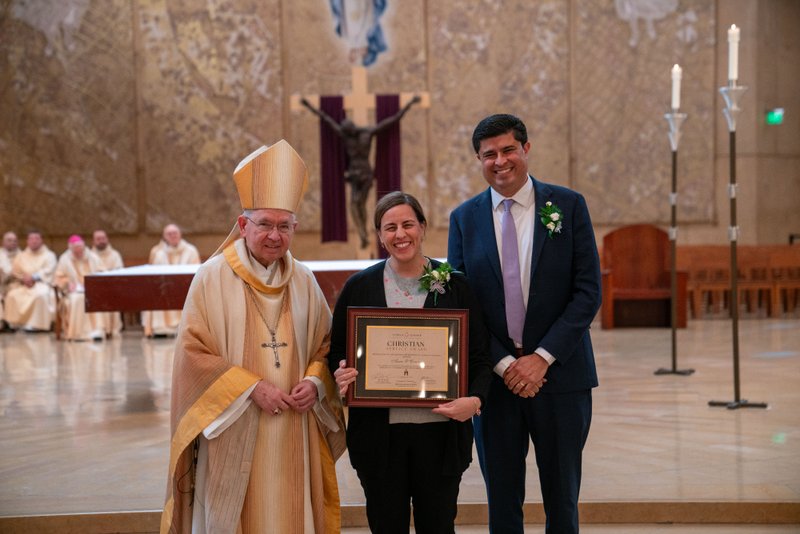 Archbishop José H. Gomez and Paul Escala, superintendent of LA Catholic schools, pose with Bishop Montgomery High School's Anne O’Connor at the 2026 Christian Service Awards Mass on March 10 at the Cathedral of Our Lady of the Angels. (John Rueda)