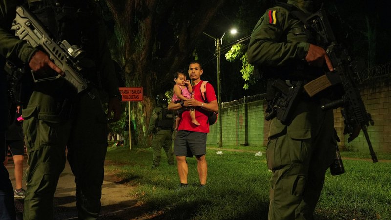 A man holding a child looks on as Colombian presidential candidate Paloma Valencia speaks during a news conference in Palmira April 25, 2026, following a deadly explosive attack on a highway in the southwestern province of Cauca. During his April 29 audience, Pope Leo XIV called for an end to violence after learning of the bombing that killed 20 people and left dozens wounded. (OSV News photo/Jair Coll, Reuters)