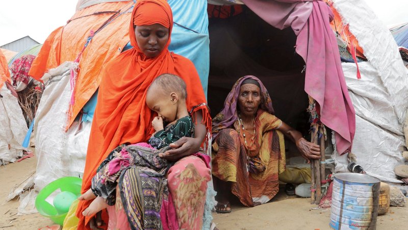A Somali woman displaced by the worsening drought due to lack of rain holds her malnourished child outside their makeshift shelter at a camp near Mogadishu Sept. 23, 2022. (CNS photo/Feisal Omar, Reuters)