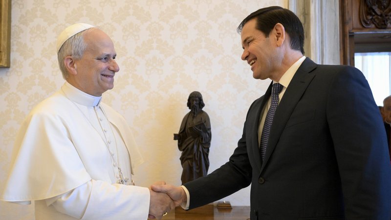 Pope Leo XIV shakes hands with Secretary of State Marco Rubio in the library of the Apostolic Palace at the Vatican May 19, 2025. (CNS photo/Vatican Media)
