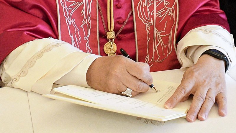 Pope Leo XIV signs his first apostolic exhortation, "Dilexi Te" ("I Have Loved You"), in the library of the Apostolic Palace at the Vatican Oct. 4, 2025, the feast of St. Francis of Assisi. His first encyclical, "Magnifica Humanitas," will be published May 25, 2026, addressing artificial intelligence and the protection of human dignity, the Vatican announced May 18, 2026. (OSV News photo/Vatican Media/CPP)