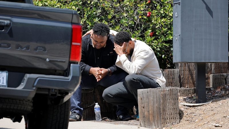 Men console each other near the scene of a shooting at the Islamic Center in San Diego May 18, 2026. Two teenage shooters opened fire at a the mosque and killed three men -- then killed themselves a few blocks away -- in an attack police are investigating as a hate crime. (OSV News photo/Mike Blake, Reuters)
