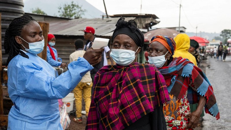 A health worker takes the temperature of a woman passing through the Kanyaruchinya checkpoint into the city of Goma, Congo May 20, 2026, as authorities and aid agencies intensify efforts to contain a new Ebola outbreak caused by the Bundibugyo strain. (OSV News photo/Arlette Bashizi, Reuters)
