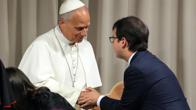 Pope Leo XIV greets Christopher Olah, co-founder of the artificial intelligence company Anthropic, at the Synod Hall at the Vatican May 25, 2026, for a presentation on the pope's first encyclical, “Magnifica Humanitas: On Safeguarding the Human Person in the Time of Artificial Intelligence.” (CNS photo/Lola Gomez)