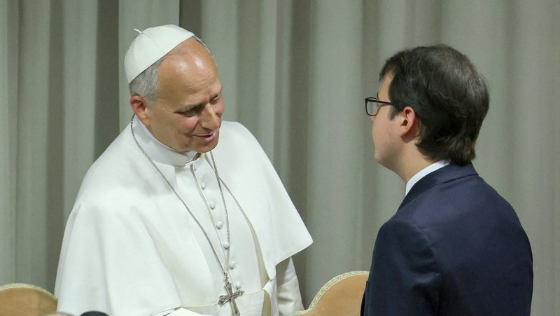 Pope Leo XIV shakes hands with Christopher Olah, co-founder of the U.S. artificial intelligence company Anthropic, during the presentation of Magnifica Humanitas at the Vatican’s Synod Hall May 25. (OSV News/Yara Nardi, Reuters)