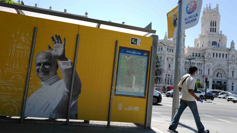A man walks past a poster of Pope Leo XIV in Madrid May 28, 2026, ahead of the pontiff's June 6-12 apostolic visit to Spain. (OSV News photo/Kacper Pempel, Reuters)
