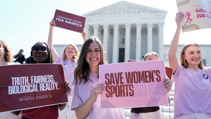 Women hold placards outside the U.S. Supreme Court in Washington June 30, 2026, as they celebrate the court's final rulings of its nine-month term, including a decision that cleared the way for states to impose restrictions on student athletes who identify as transgender, upholding laws in West Virginia and Idaho banning them from female sports teams. (OSV News photo/Cheney Orr, Reuters)