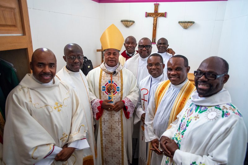 Cardinal Peter Ebere Okpaleke of Ekwulobia, Nigeria, poses with priests and deacons before a special May 31 Mass at St. Eugene Church in South LA. The cardinal visited LA as part of a tour visiting Nigerian Catholics living in the U.S. (Michael Goulding)