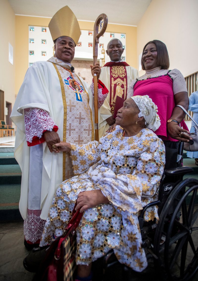 Cardinal Peter Ebere Okpaleke of Ekwulobia, Nigeria, blesses a woman in a wheelchair following a special May 31 Mass at St. Eugene Church in South LA. The cardinal visited LA as part of a tour visiting Nigerian Catholics living in the U.S. (Michael Goulding)