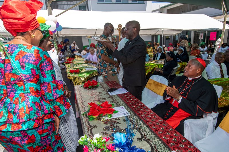Cardinal Peter Ebere Okpaleke of Ekwulobia, Nigeria, right, sits during a reception in the parking lot of at St. Eugene Church in South LA following a special May 31, 2026 Mass. (Michael Goulding)
