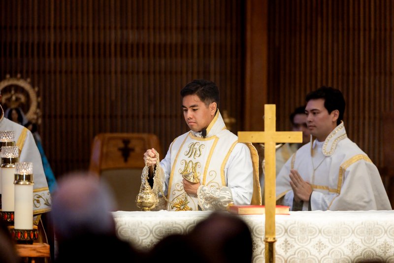 Father Jerick Alenton dispenses incense around the altar during his first Mass at his home parish of St. Clare of Assisi Church in Santa Clarita on May 31. (Joe Garcia III)