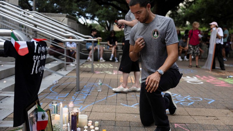 A man makes the sign of the cross at a makeshift memorial during a vigil in Houston July 11, 2026, in response to the fatal shooting of a Mexican motorist by an Immigration and Customs and Enforcement agent during a vehicle stop. Lorenzo Salgado Araujo, a Mexican national who lived in the U.S. for decades, was fatally shot July 7 as the homebuilder drove his construction crew to a Houston job site. A spokesman for the Department of Homeland Security said the ICE agent fired his weapon "in self-defense" when Salgado allegedly rammed an ICE vehicle with his own vehicle. The claim has been disputed and a federal investigation is underway. (OSV News photo/Antranik Tavitian, Reuters)
