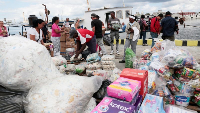 Members of a flotilla that departed from Mexico, together with local port workers, unload humanitarian aid upon their arrival to Havana's bay March 24, 2026. Catholic Relief Services, the humanitarian and development agency of the U.S. Catholic bishops, has received $60 million from the U.S. State Department to expand humanitarian assistance to vulnerable families across Cuba. (OSV News photoJorge Luis Banos pool via Reuters)