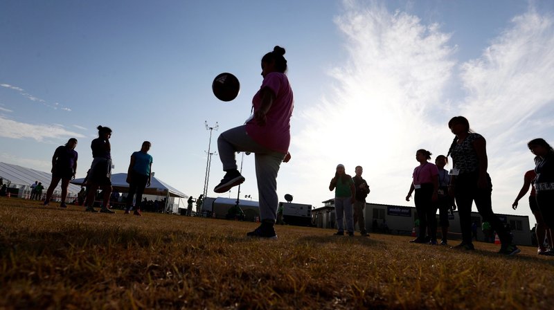 Young immigrants are seen in a file photo playing soccer at holding center for unaccompanied migrant children in Carrizo Springs, Texas. Estrella del Paso, a Catholic ministry of the Diocese of El Paso, Texas, that serves tens of thousands, has exhausted its reserves after seven months of not receiving payment from the federal government for its program that represents unaccompanied immigrant children. (OSV News photo/Eric Gay, pool via Reuters)
